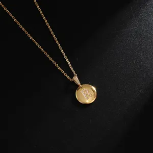 Detail shot of gold-plated stainless steel letter R pendant necklace with sparkling stones.