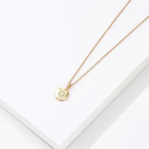 Detailed view of gold stainless steel letter pendant necklace with sparkling crystal pave.