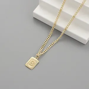 Close-up detail of a stylish gold-plated cuban chain necklace featuring a rectangular letter B pendant.