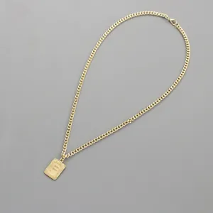 Detailed view of gold-tone chain necklace featuring a rectangular initial letter F pendant.