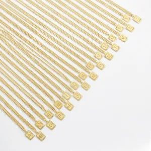 Gold letter pendant necklace detail, initial alphabet charm on delicate chain accessory