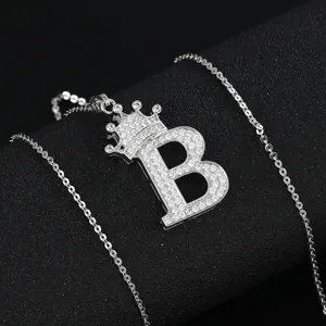 Detail shot of micro-pave cubic zirconia letter B pendant necklace with crown design.
