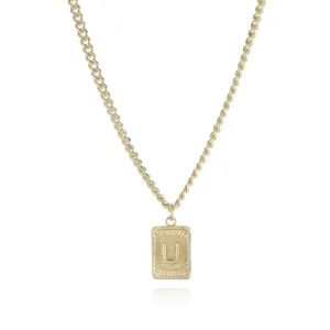 Gold initial letter U pendant necklace detail shot showcasing the textured rectangular design.