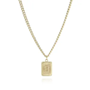 Gold rectangular initial B pendant necklace detail, elegant engraved metal link chain jewelry.