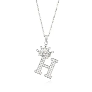 Close up detail of sparkling micro pave zircon crown letter H pendant necklace in silver.
