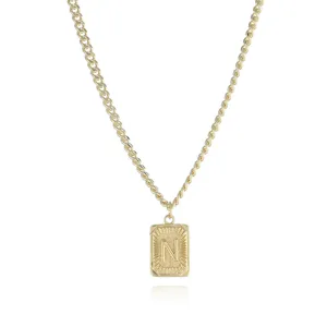 Detailed close-up view of the gold-plated metal necklace featuring a rectangular letter N pendant.