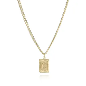 Gold tone rectangular initial letter C pendant necklace closeup metal chain jewelry