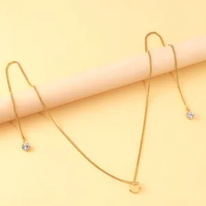 Gold-tone rhinestone chain lip ring accessory detail shot showing delicate metal craftsmanship.