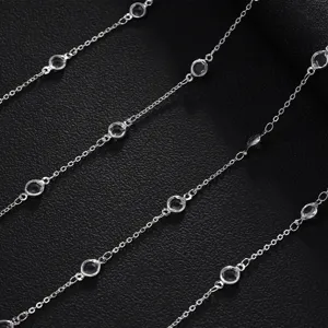 Detailed close-up of sparkling clear rhinestone station chains on a chic black background.
