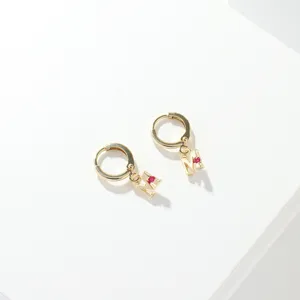 Gold hoop earrings with letter M pendant and red crystal stone, stylish daily jewelry accessory.
