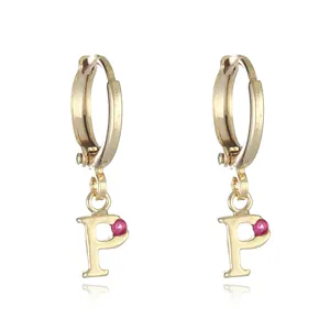 Close-up view of the gold letter P charm hoop earrings with pink gemstone detail.