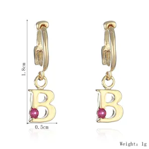 Gold tone letter B pendant hoop earrings detail view showcasing gemstone inlay and dimensions.