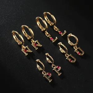 Gold plated letter pendant hoop earrings set featuring sparkling red crystal stones detail.
