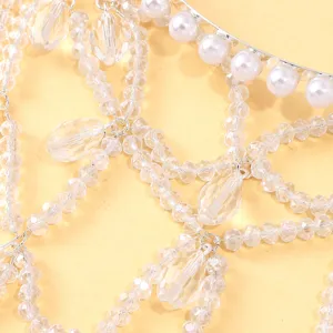 Gedetailleerde close-up van fonkelende kristallen haaraccessoire met parels en zilveren ketting.