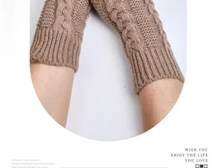 Detailed view of brown cable-knit arm warmers, half-finger winter wool wrist sleeves.