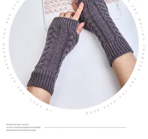 Detailed close up view of dark grey cable knit fingerless gloves, cozy winter warmers.