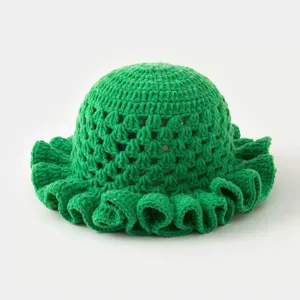 Detail view of a handmade green crochet hollow bucket hat with a stylish ruffled brim.