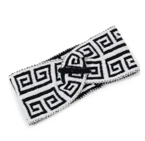 Black and white knitted headband with geometric Greek key pattern and stylish twist knot.