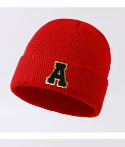 Red knit beanie detail showing the stylish letter A patch, warm and cozy for autumn winter.