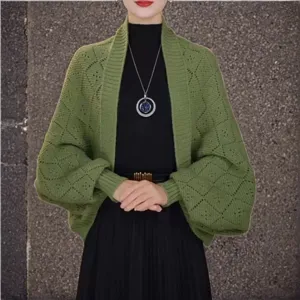 Green knit batwing cardigan detail view, showing grid pattern texture and loose drape style.
