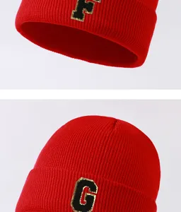 Close-up detail view of red knitted beanie with stylish glitter letter patch for winter.