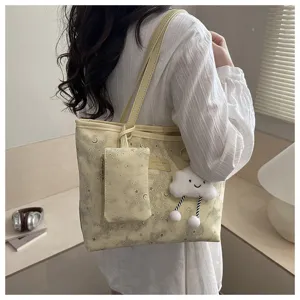 Chic star moon printed tote bag with matching pouch and cute cloud pendant for women.