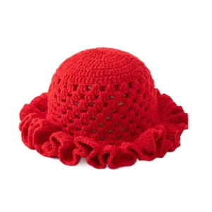 Handmade red crochet bucket hat with hollow knit pattern and ruffled brim for summer.