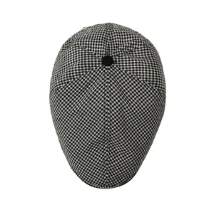 Detailed view of womens black and white checkered flat cap, casual ivy cap for autumn.