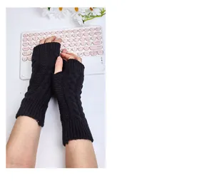 Detailed view of black knitted fingerless gloves, warm winter wrist warmers for daily wear.