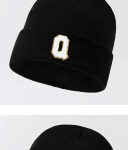 Black knitted beanie hat with white letter Q patch, warm winter streetwear for men and women.