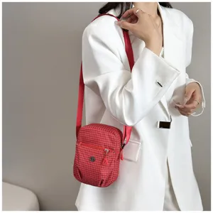 Detailed view of a red plaid mini crossbody phone bag, casual lightweight design for women.