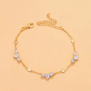 Gold rhinestone anklet detail showcasing sparkly teardrop crystals and dainty chain links.