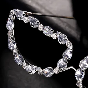 Exquisite rhinestone glasses frame detail, luxury teardrop crystal fashion party eyewear accessory.
