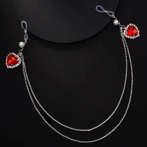 Detailed shot of sparkling red heart rhinestone nipple chain, sexy body jewelry for party wear.