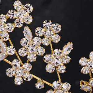 Detailed shot of sparkling rhinestone floral bridal hair accessory, elegant golden wedding piece.