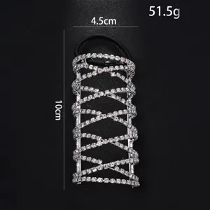 Detail shot of rhinestone ponytail cuff with cross design, sparkling crystals, and elastic band.