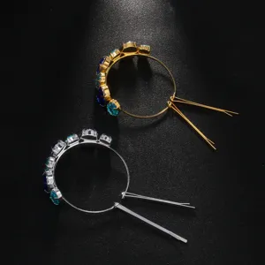 Detailed view of the elegant rhinestone hair ring showcasing sparkling blue and turquoise stones.