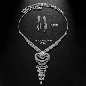 Silver rhinestone jewelry set with multi-layer heart necklace and dangling earrings.