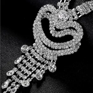Close-up detail of multi-layer rhinestone heart tassel necklace bridal jewelry accessory.