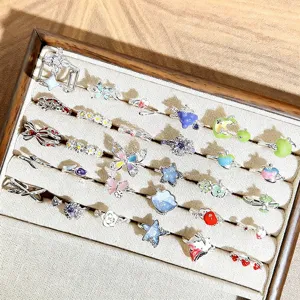 Sweet cartoon fruit enamel ring set with star and butterfly motifs, stackable open detail.