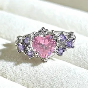 Detailed close-up of a sweet vintage silver heart ring with pink and purple cubic zirconia.