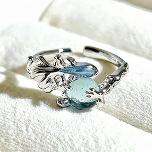 Exquisite sweet style open ring with blue bead and creative organic design, detailed macro view.