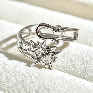 Close-up detail of the sparkling star open ring, showcasing exquisite craftsmanship and metallic shine.