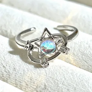 Close-up detail of the sweet celestial open ring featuring star and iridescent orb design.