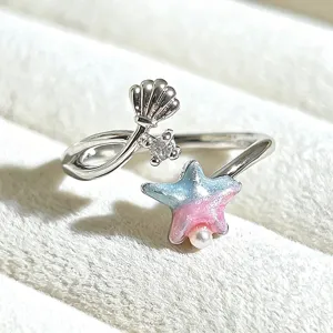 Close-up detail of a sweet girl style enamel open ring with cute star and pearl accents.