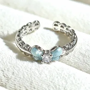 Close-up detail of a sweet enamel butterfly open ring with sparkling cubic zirconia stone.