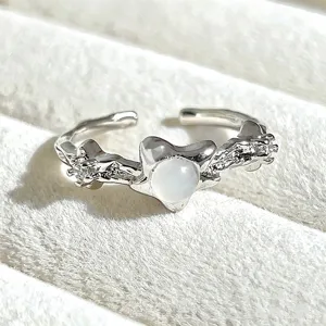 Sweet silver open ring with white stone star design, delicate fashion jewelry detail view.