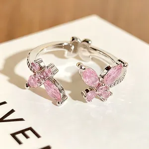Nahaufnahme des koreanischen rosa Zirkon Schmetterlings offenen Rings im Y2K-Stil.