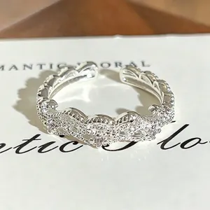 Detailed close-up shot of sparkling cubic zirconia adjustable open ring, exquisite design.