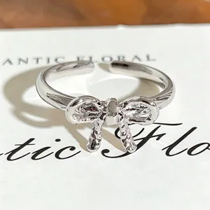 Silver bow open ring for women, stylish minimalist metal jewelry for daily wear and stacking.